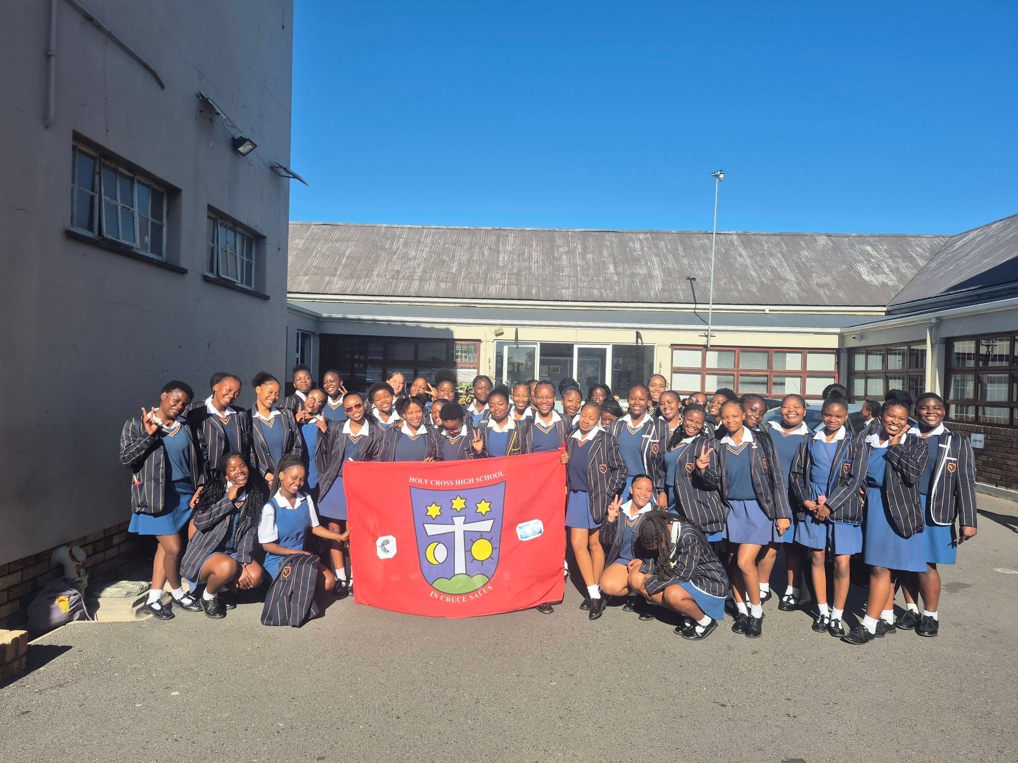 Holy Cross High School students with the school flag